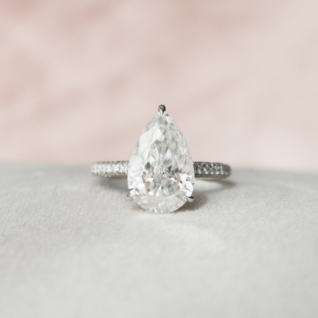 Pear shape moissanite hidden halo engagement ring in gold