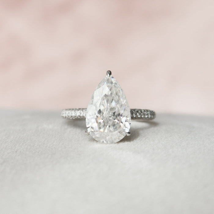 Pear shape moissanite hidden halo engagement ring in gold