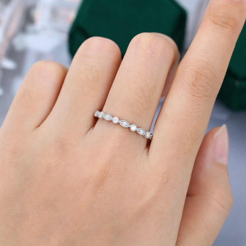 Round moissanite milgrain vintage wedding band in white gold worn on the finger