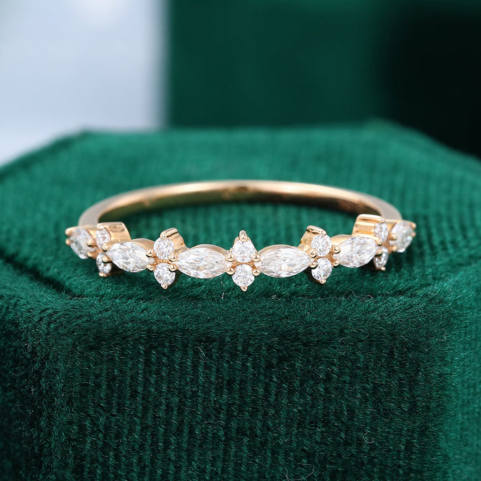 Front view of a marquise and round moissanite floral cluster wedding band in yellow gold