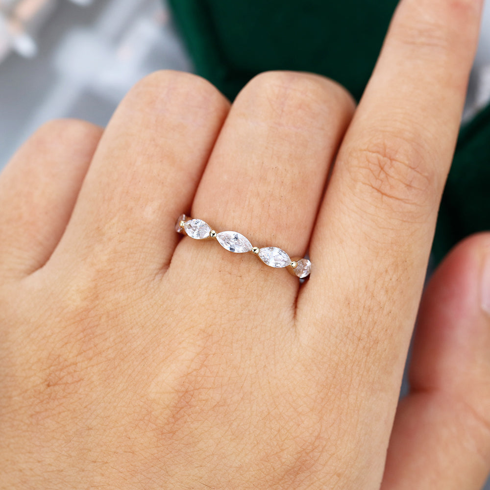 Marquise moissanite bubble prong full eternity wedding band in yellow gold worn on the finger