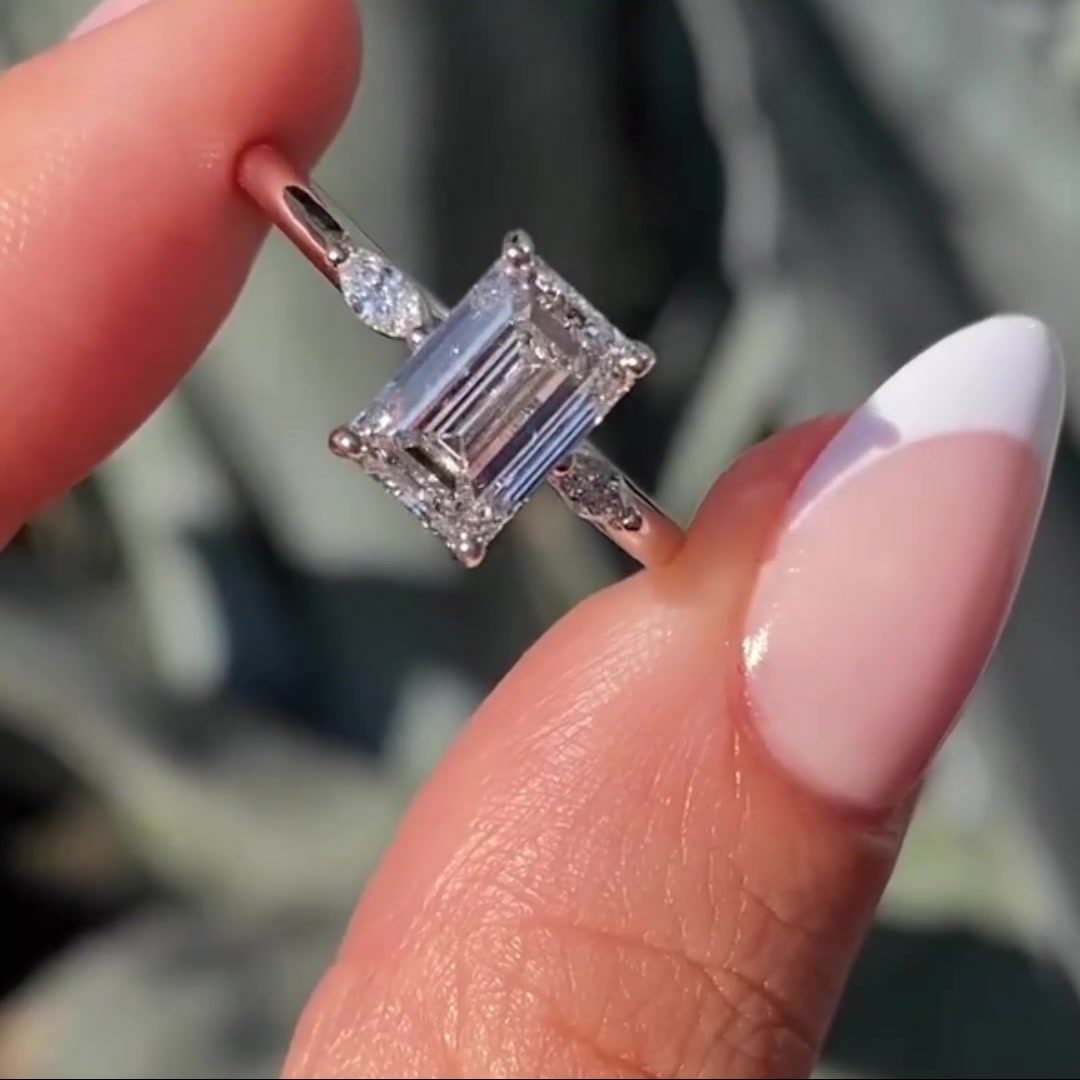 3 stone emerald cut moissanite engagement ring with cathedral setting in 14K yellow gold