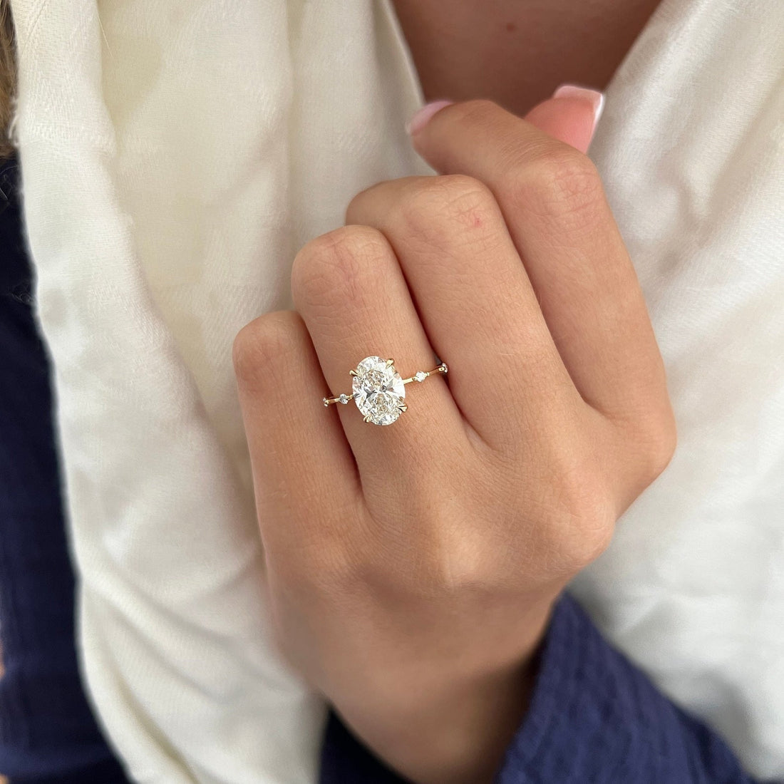 Oval cut lab grown diamond hidden halo ring with station set accent band