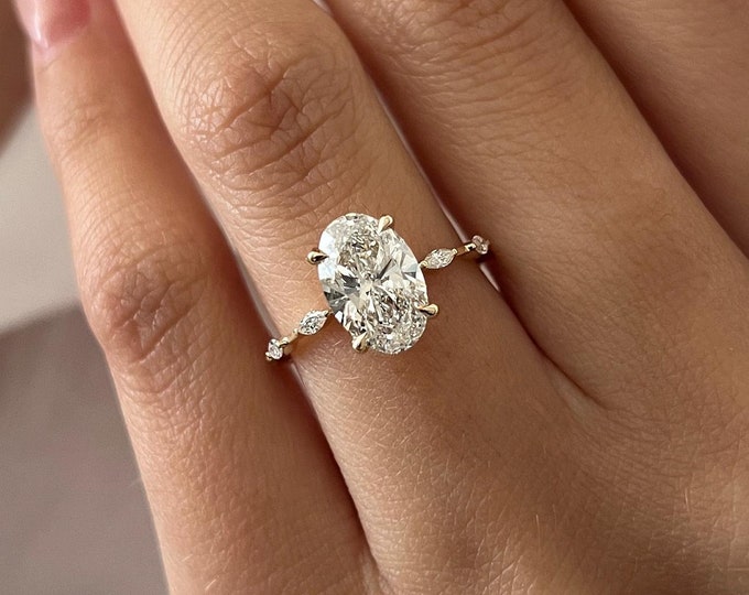 Oval cut lab grown diamond hidden halo ring with marquise and round side accents