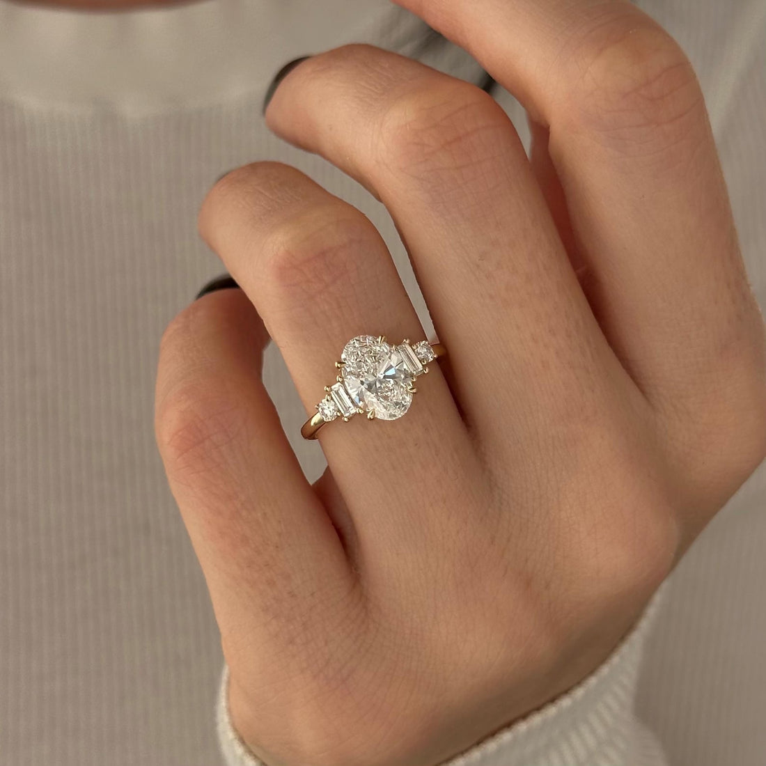 Oval cut lab grown diamond art deco ring with graduated baguette shoulder clusters