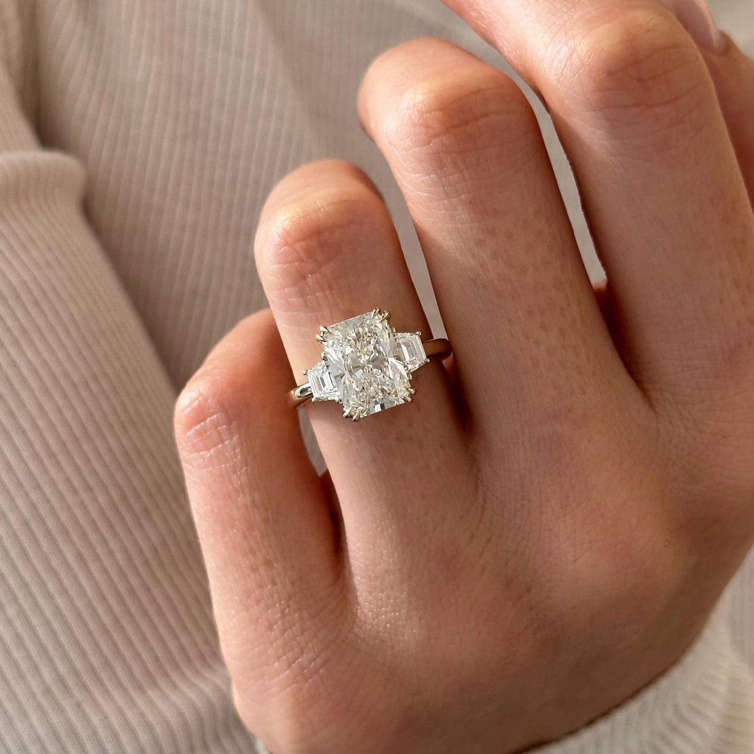 Radiant cut lab grown diamond three stone ring with trapezoid side stones