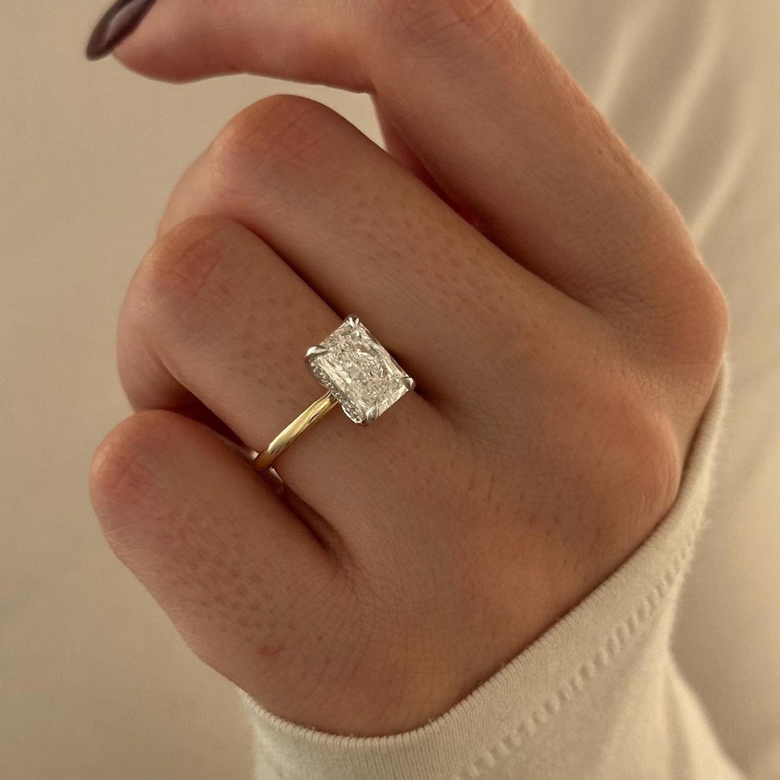Elongated radiant cut lab grown diamond hidden halo ring on a thin band