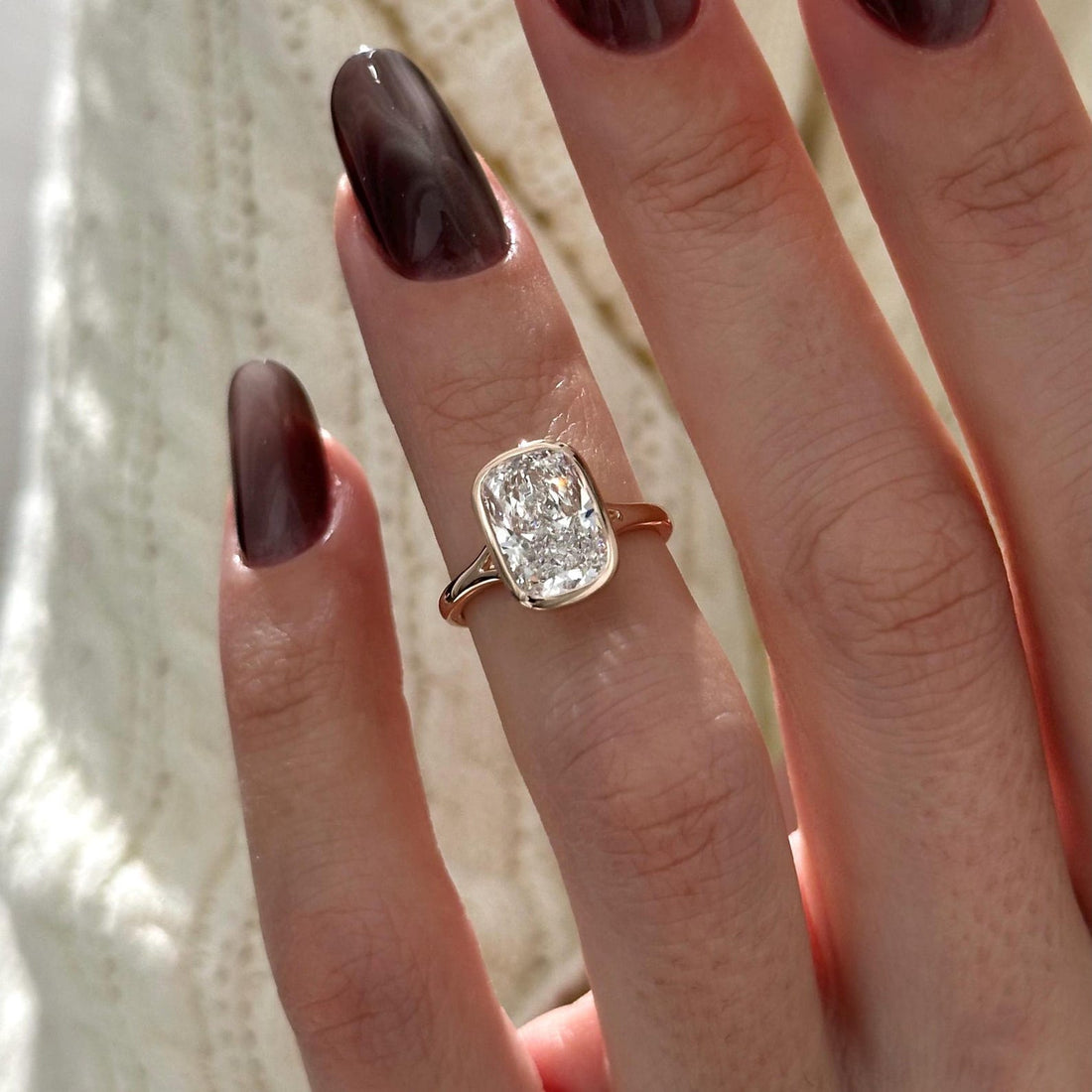 Bezel set elongated cushion cut lab grown diamond solitaire ring