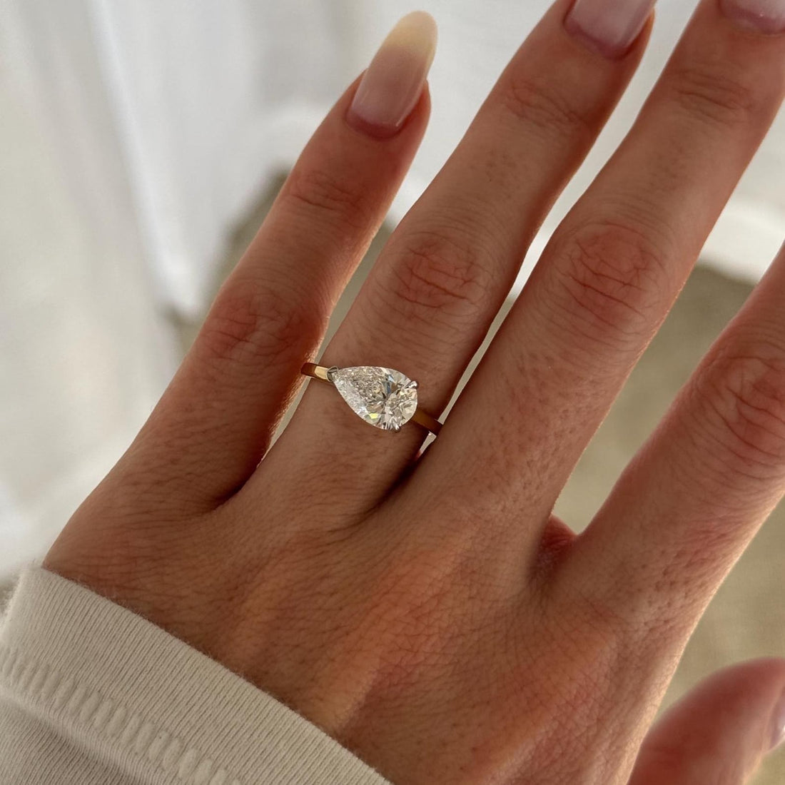 East west pear cut lab grown diamond claw set solitaire ring
