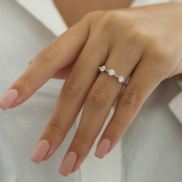 Dainty round lab grown diamond wedding band on hand