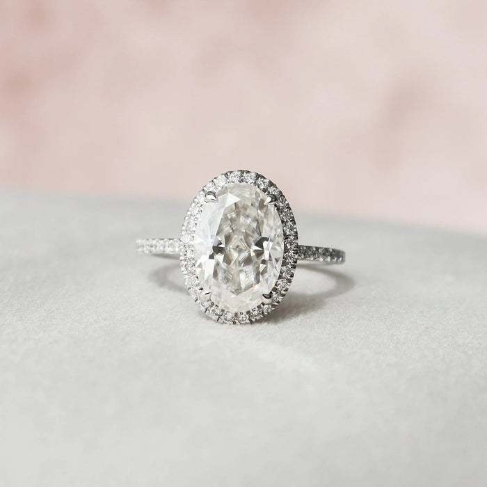 Oval cut halo moissanite engagement ring in gold