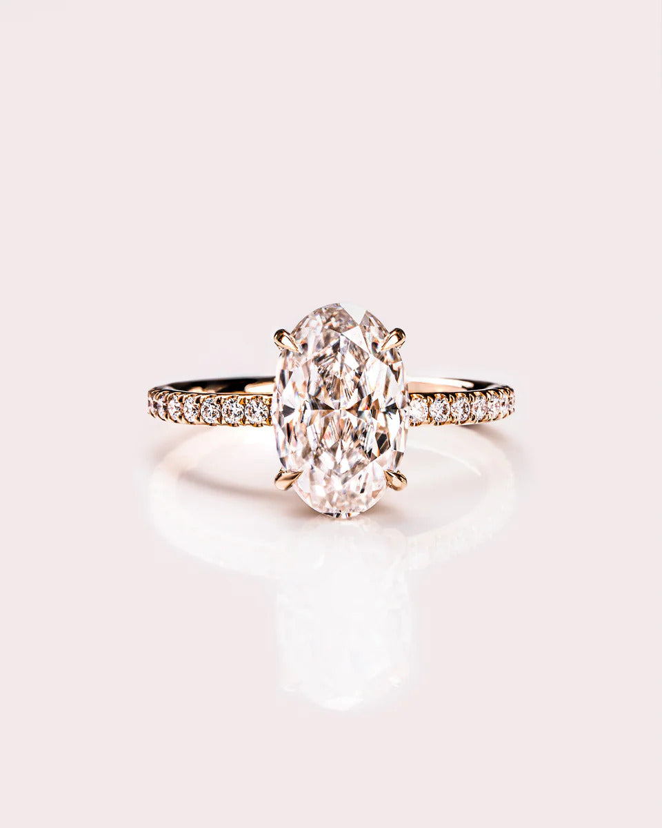 Oval cut moissanite hidden halo engagement ring with eternity band in gold