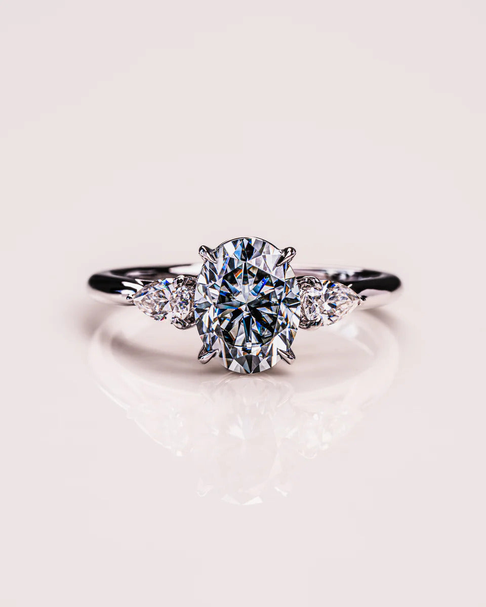 Oval moissanite art deco engagement ring with round cluster in gold
