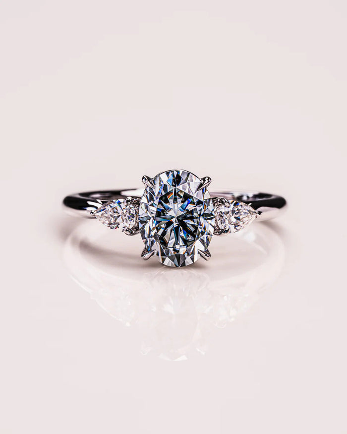 Oval moissanite art deco engagement ring with round cluster in gold