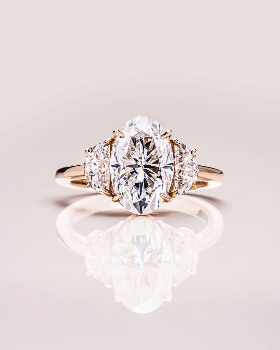 Oval three stone moissanite engagement ring in gold