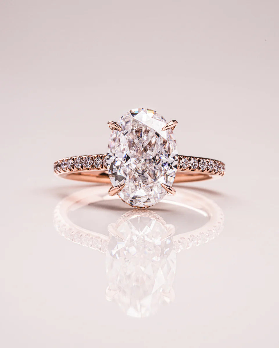 Oval moissanite engagement ring set with pave band in gold