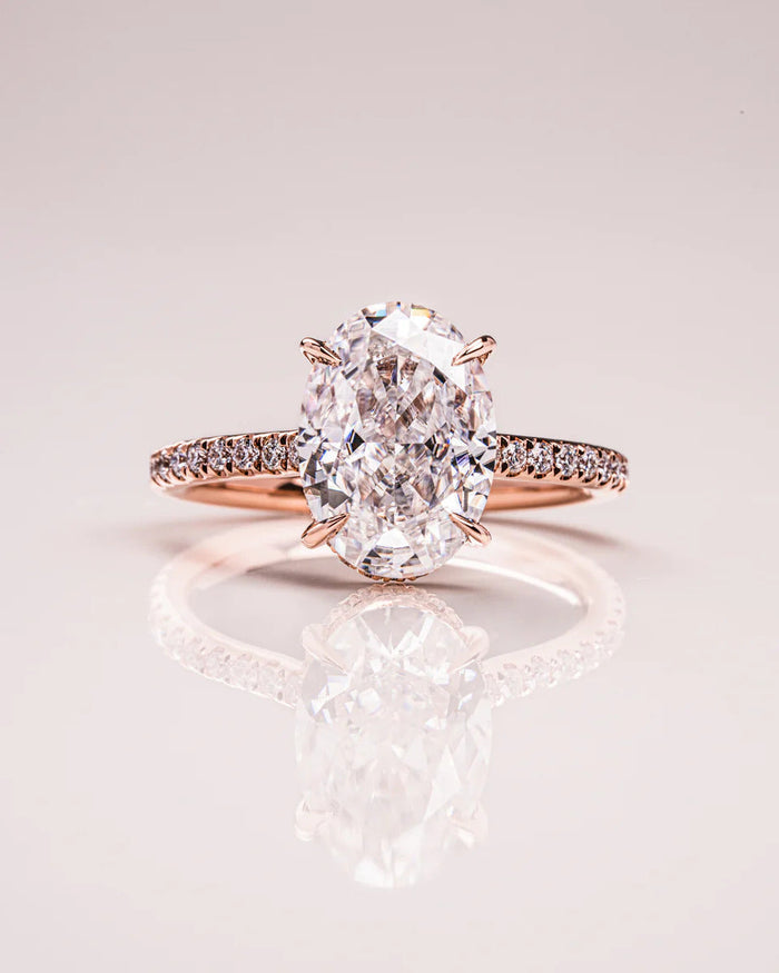 Oval moissanite engagement ring set with pave band in gold