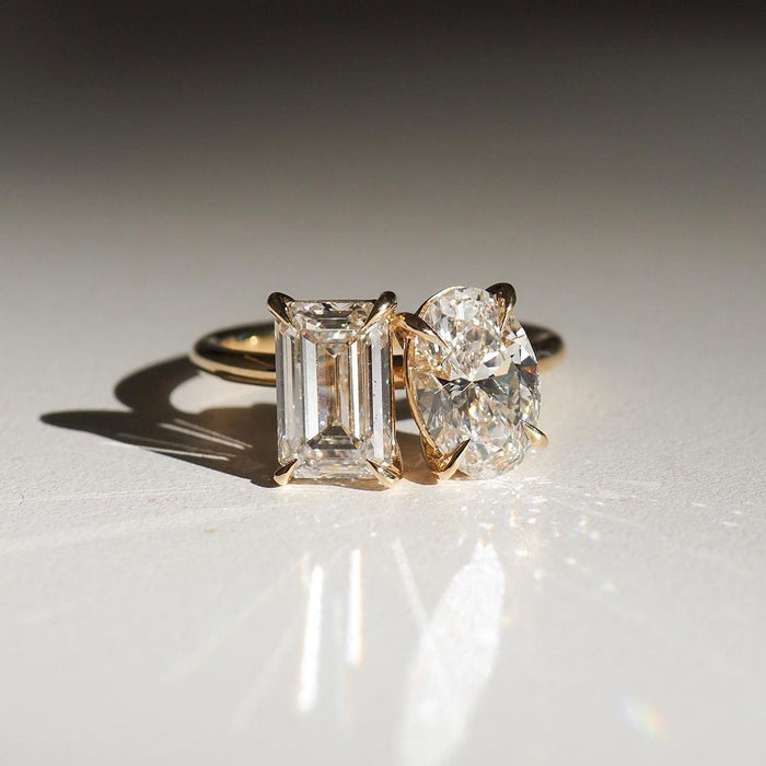 Emerald and oval moissanite Toi et Moi ring in 14K gold
