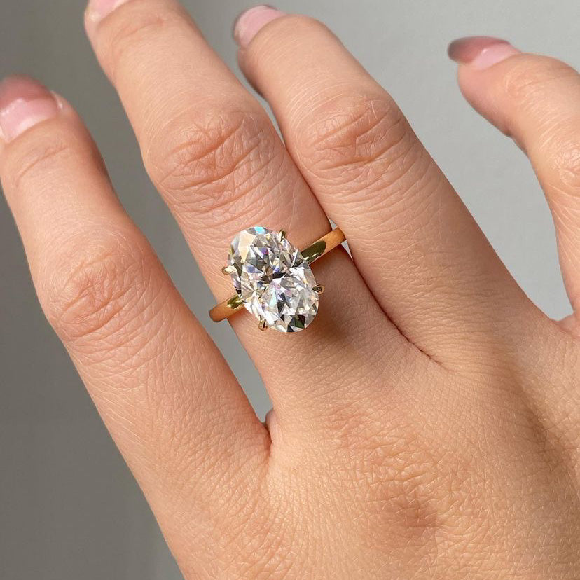 Oval cut moissanite solitaire engagement ring in solid gold