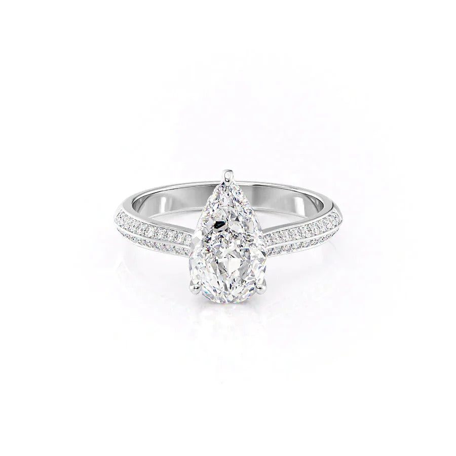Pear cut halo moissanite engagement ring with stacking band in gold