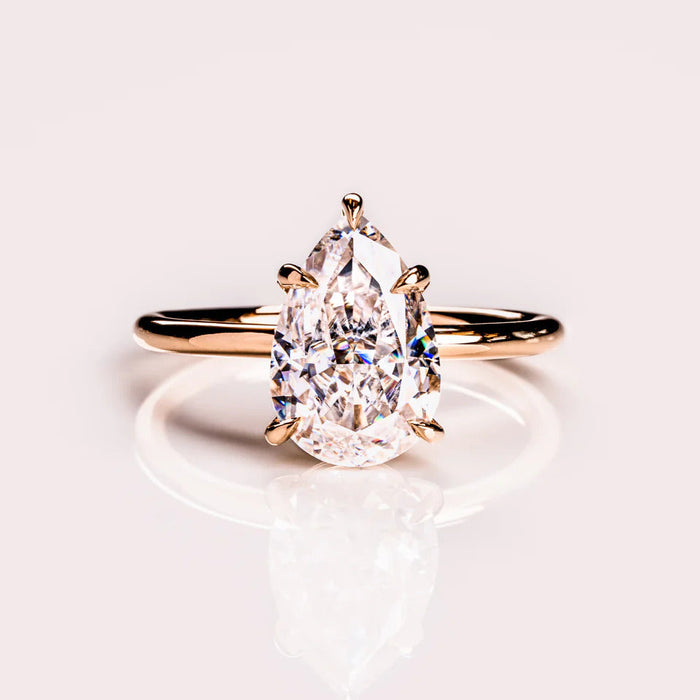 Pear cut moissanite solitaire engagement ring in gold
