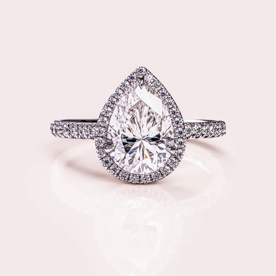 Pear cut halo moissanite engagement ring in gold