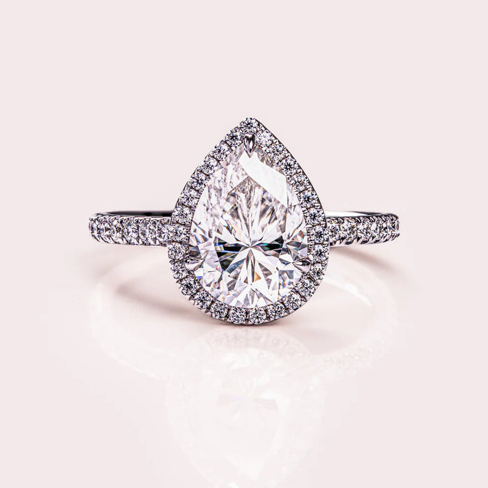 Pear cut halo moissanite engagement ring in gold