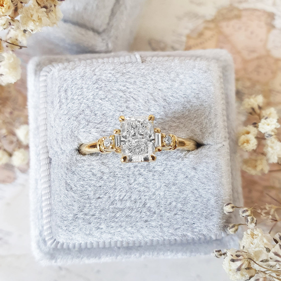 Radiant cut lab grown diamond five stone ring with baguette and round sides in yellow gold
