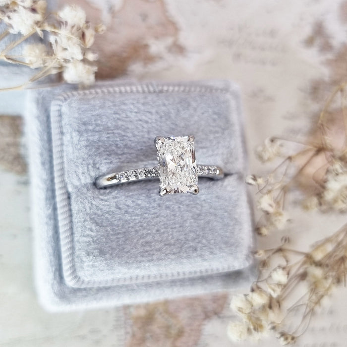 Top view of the radiant cut diamond with pave running down the shoulders