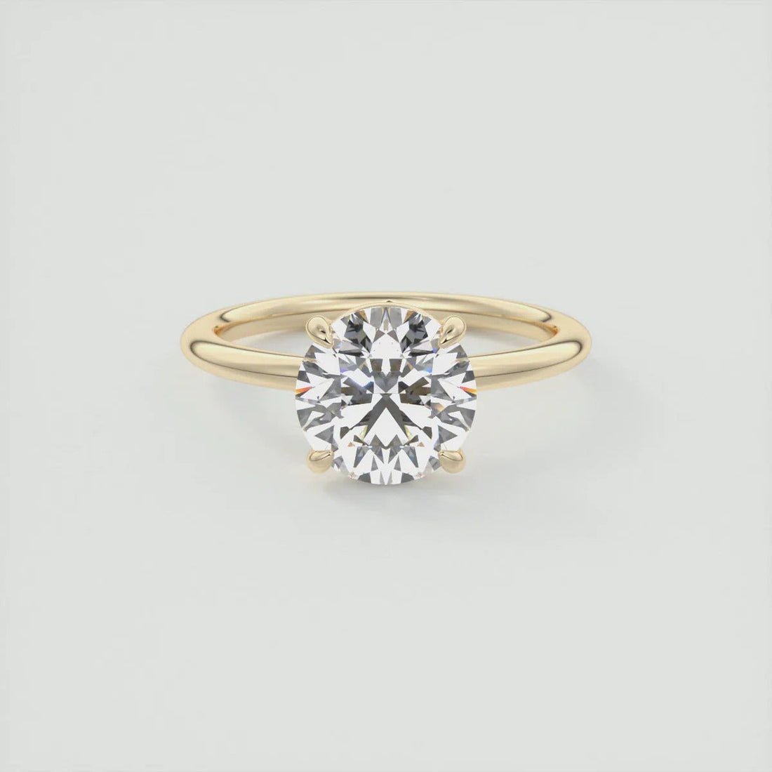 Round cut moissanite solitaire engagement ring in gold