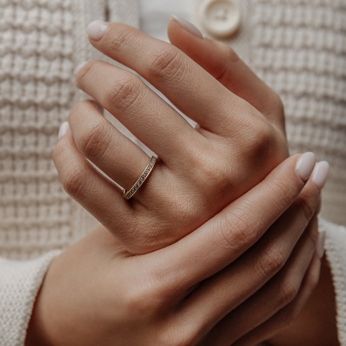 Round lab grown diamond channel set wedding band on hand