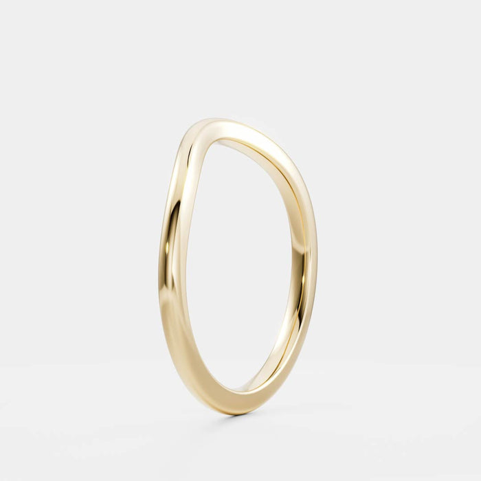 Classic curved plain wedding band in yellow gold, angled view