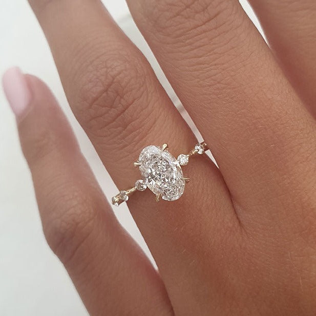 Elongated oval cut moissanite dainty solitaire engagement ring on hand