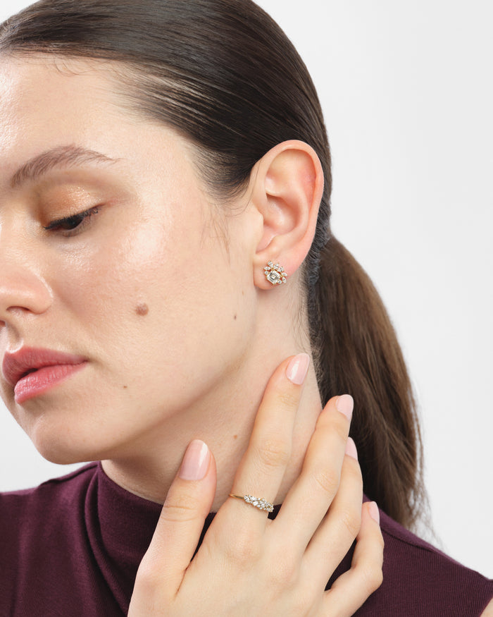 Model wearing asscher cluster halo lab grown diamond stud earrings, close up on the ear