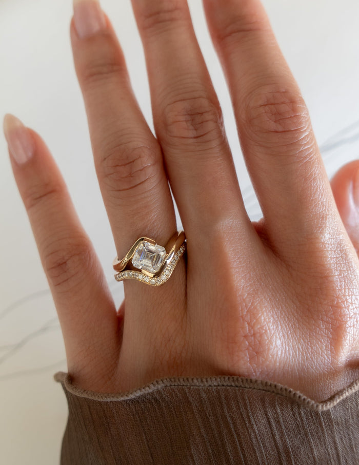 Asscher lab grown diamond bypass engagement ring and angled pave wedding band on the hand