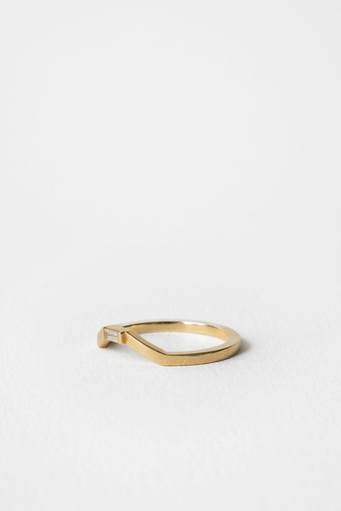 Baguette moissanite curved wedding band in yellow gold, side view