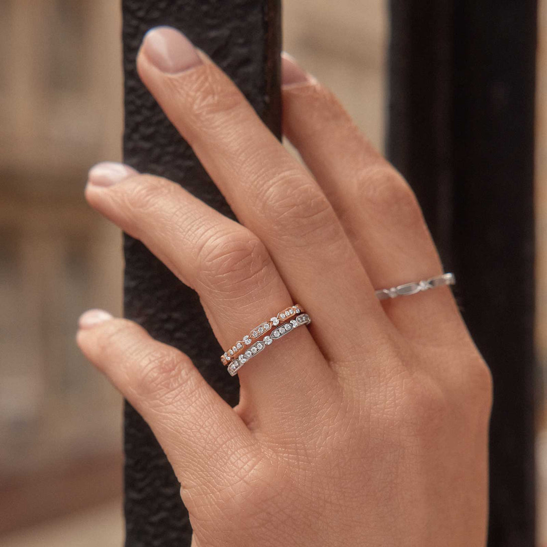 Round lab grown diamond full eternity wedding bands stacked in rose gold and white gold on a hand