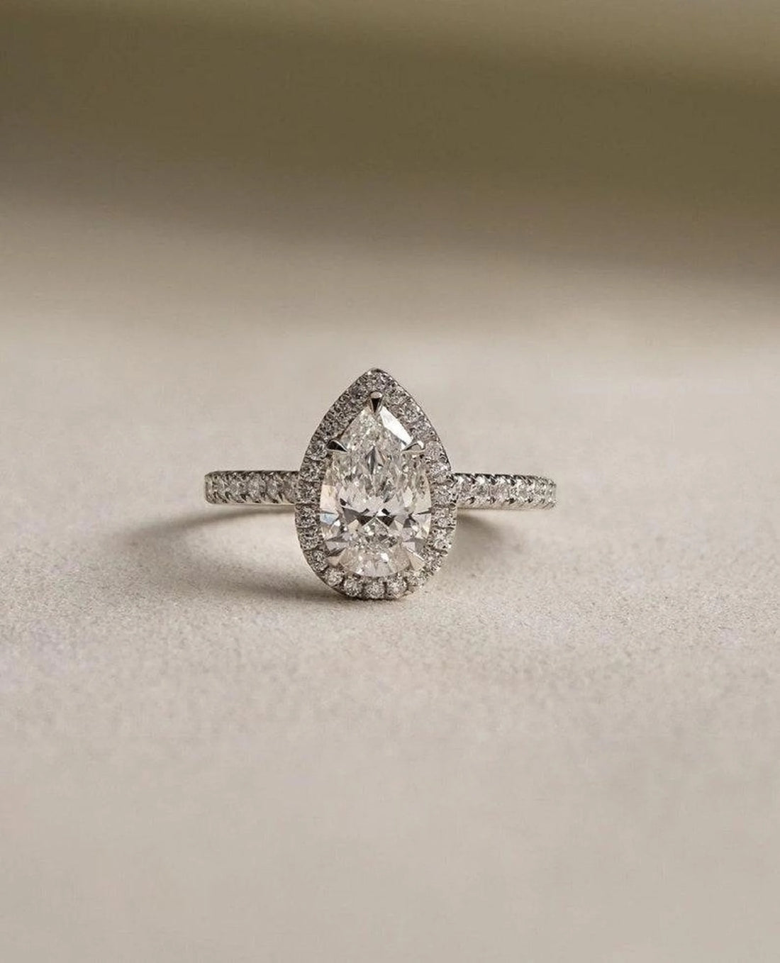 Pear cut lab grown diamond halo ring, detail of the pave set band