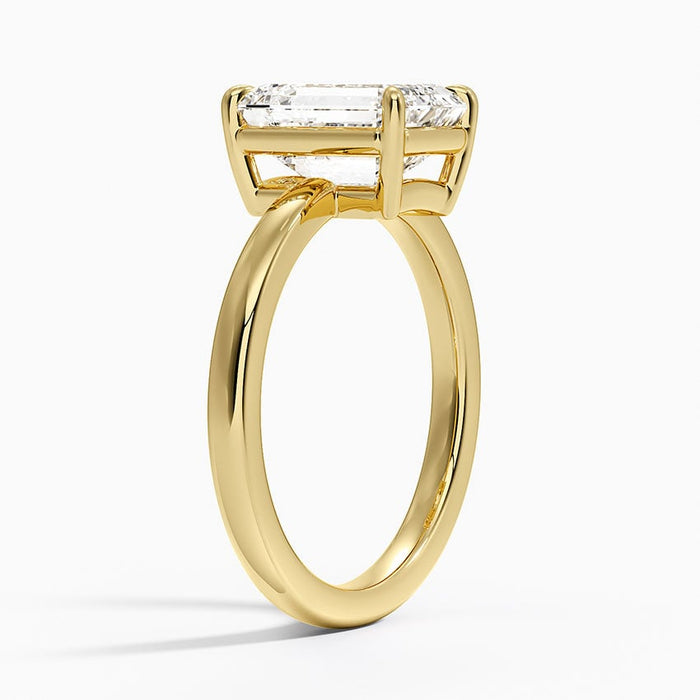 Profile view showing the squared open basket under the emerald cut diamond