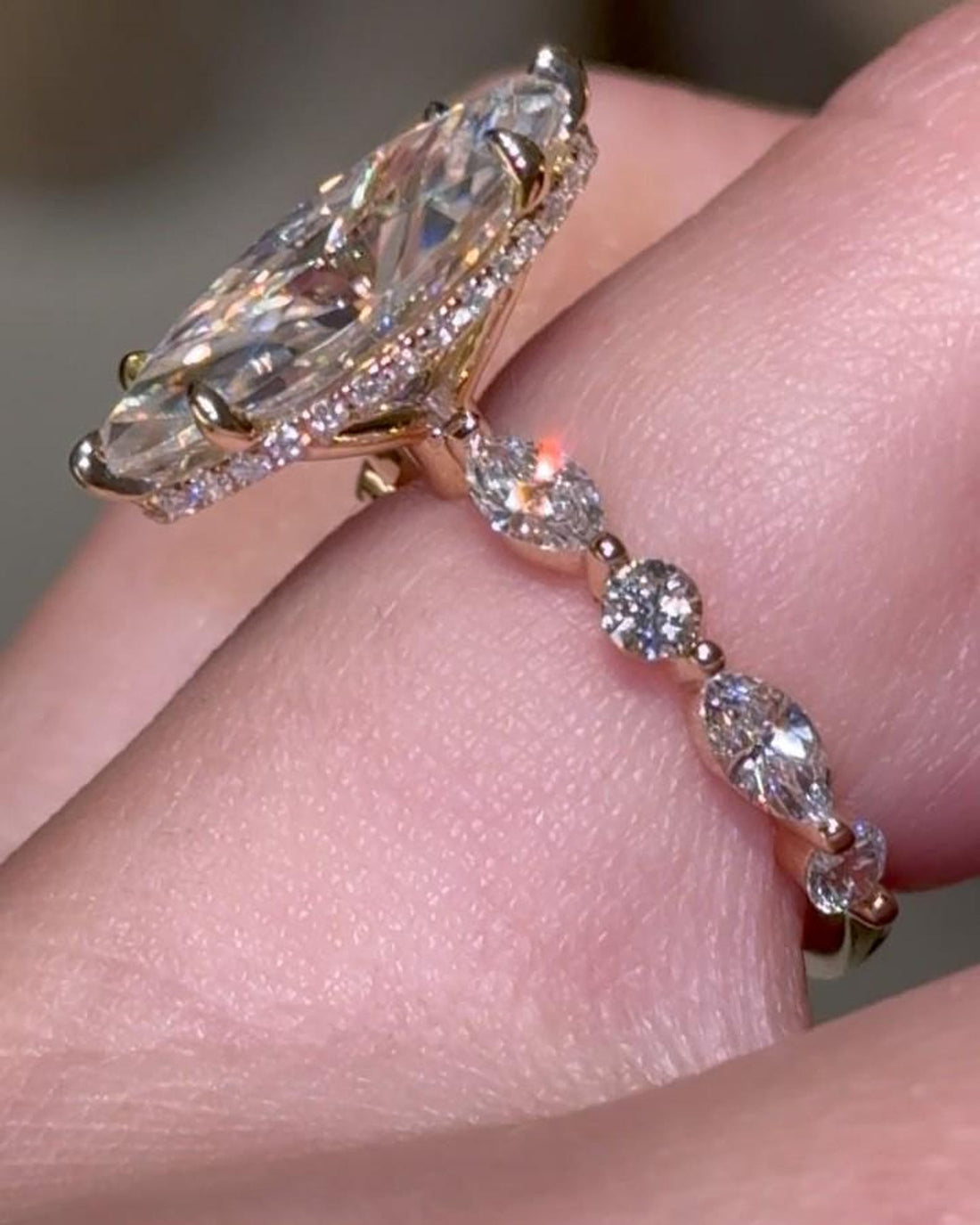 Marquise cut lab grown diamond engagement ring with hidden halo on a marquise and round accent band in rose gold