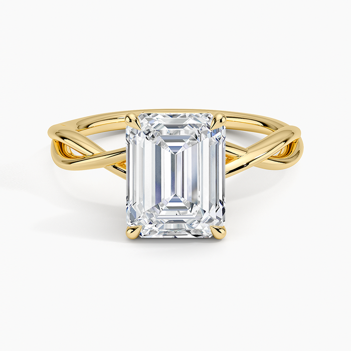 Emerald cut lab grown diamond solitaire ring in yellow gold on an open interlaced twist band, top view