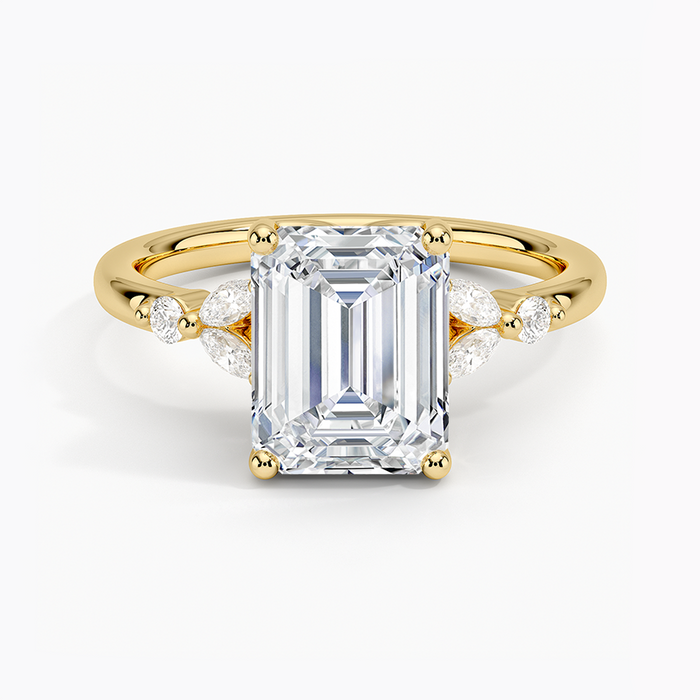 Emerald cut lab grown diamond ring in yellow gold with marquise petals and round accents at each side, top view