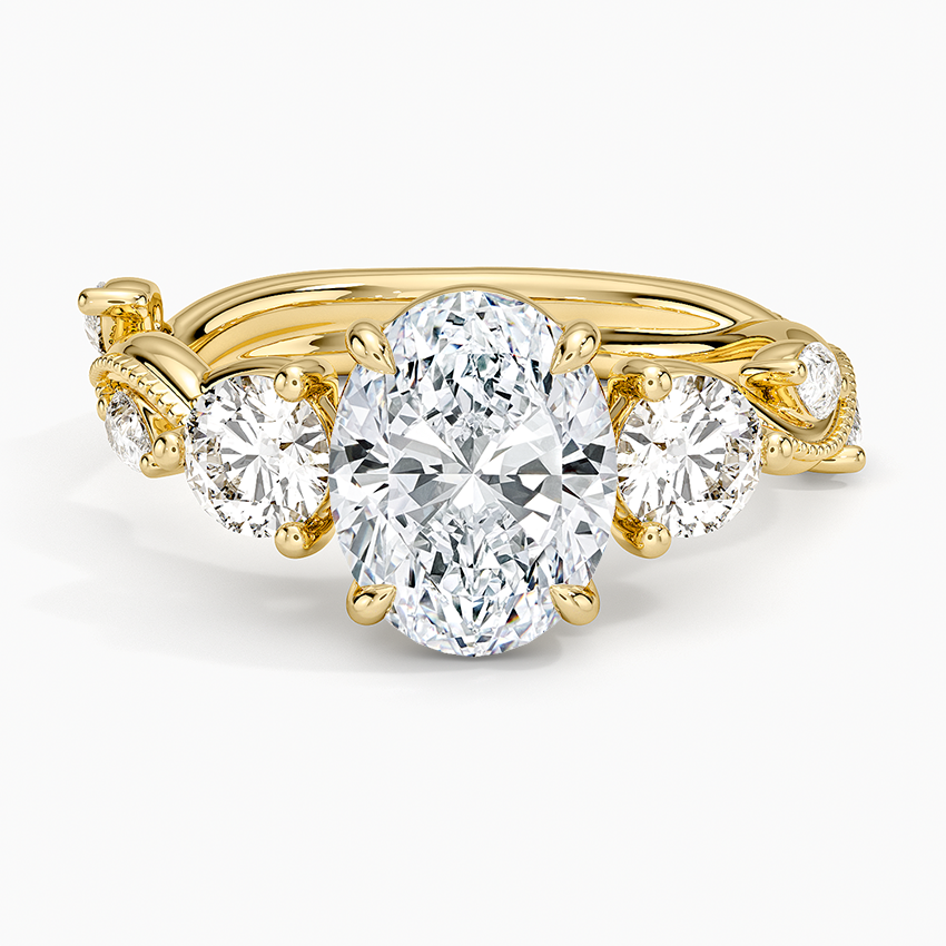 Oval cut lab grown diamond ring with round sides on a curling vine band with marquise leaves in yellow gold, top view