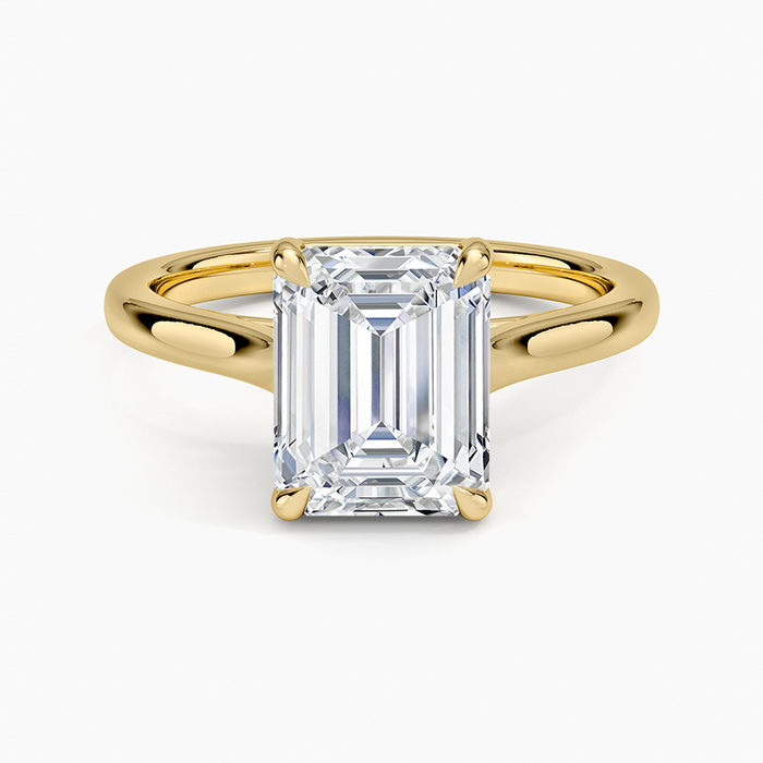 Emerald cut lab grown diamond solitaire ring in yellow gold with open cut out shoulders, top view