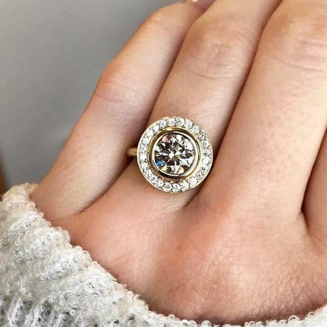 Round cut lab grown diamond halo cluster engagement ring with bezel setting