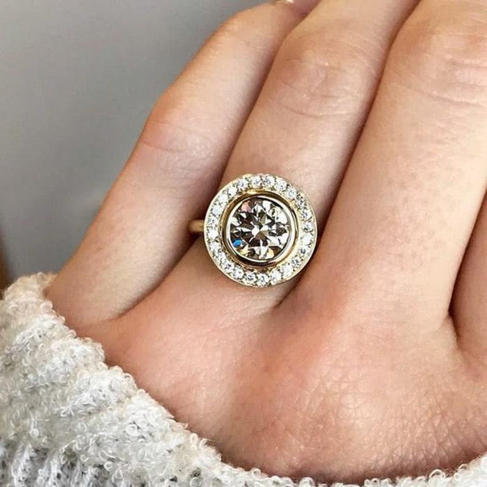 Round cut lab grown diamond halo cluster engagement ring with bezel setting