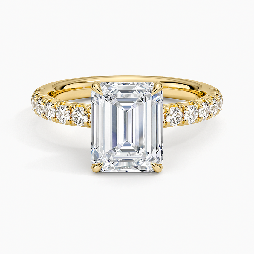 Emerald cut lab grown diamond ring in yellow gold with French set pave shoulders, top view