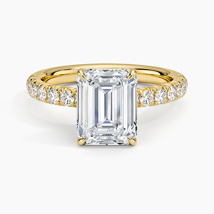 Emerald cut lab grown diamond ring in yellow gold with French set pave shoulders, top view
