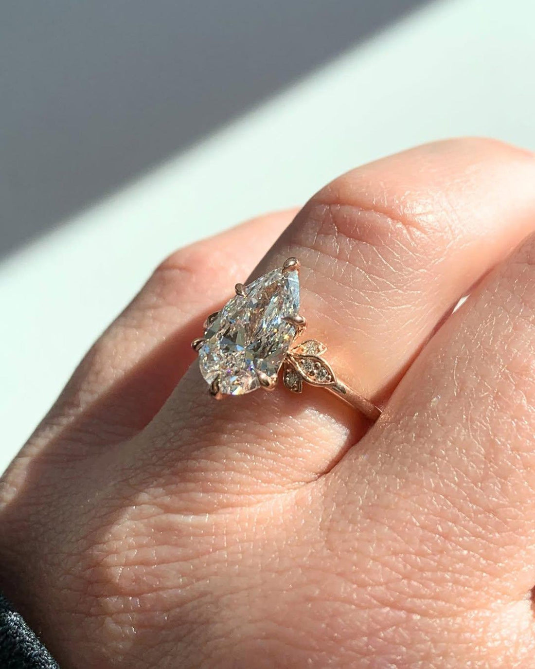 Floral pear cut lab grown diamond engagement ring with marquise leaf accents in rose gold