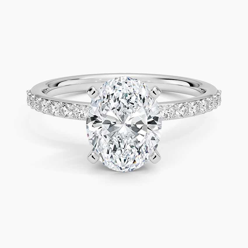 Oval cut lab grown diamond ring on a shared prong pave white gold band, top view
